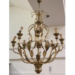 A large giltwood and toleware eight light chandelier, the baluster stem issuing scrolling leaf-