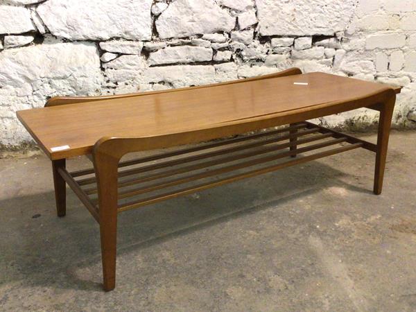 A Vintage mid century teak coffee table, the rectangular top raised on square splayed supports