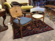 An Edwardian inlaid corner chair, upholstered in striped fabric, raised on square tapered