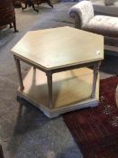 A contemporary light oak veneered coffee table of octagonal outline, the top tier raised on turned