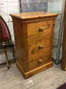 A modern polished pine bedside chest, fitted with three drawers, raised on skirted base, H86cm,