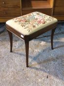 A reproduction Regency style mahogany dressing table stool, with floral needlework upholstered