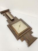 A 1920s/30s oak wall barometer complete with thermometer with silvered dial (64cm x 24cm)