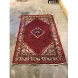 A North West Persian style rug with central diamond medallion on a multiple boteh field within a