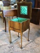 A 1940s walnut veneered sewing table, the hinged tray top revealing lined interior, above a single