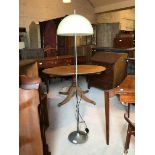 A vintage mid century standard lamp, with moulded domed shade on a silvered stem and circular