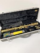 A Symphony brass saxophone complete with mouthpiece, two attachments, hard carrying case etc.