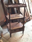 A Victorian rosewood three tier whatnot, the top with scalloped gallery, single drawer to base,