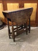 A late 18thc oak gateleg table, the oval top with two drop leaves raised on ring and block turned