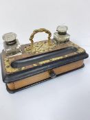 A Victorian walnut brass mounted twin inkstand with serpent handle to top, with ebonised border
