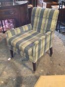 An Edwardian easy chair, upholstered in tartan patterned wool, raised on square tapered supports