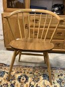 Ercol - A blonde beech and elm 'cowhorn' chair, with spindle back and turned supports H76cm,