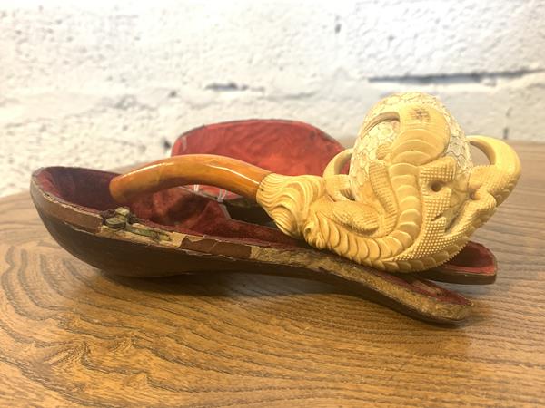 A late 19th c. meerschaum pipe in the form of a dragon's claw holding and egg, in original