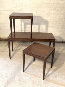 A Vintage mid century teak nest of three tables, each raised on square tapered supports H44cm,