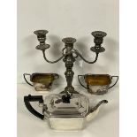 An Epns candelabra with central candleholder flanked by two candleholders, on scrolling arms (