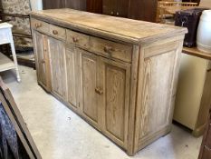 A Victorian style pine dresser base, the rectangular moulded top over four drawers and four panelled