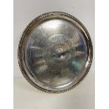 An Epns footed salver, the centre of well with foliate decoration, base stamped G& S Ltd. within a