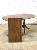 A Reproduction regency design mahogany twin pillar dining table, cross banded oval top with reeded