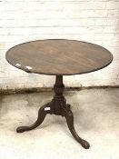 A 19th century mahogany tilt top table, the circular tray top over bird cage and baluster turned