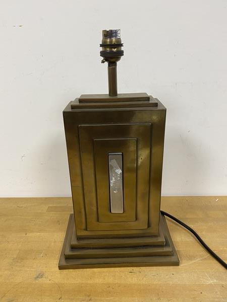 A modern Art Deco style table lamp with polished metal exterior bears stamp to base David Hunt