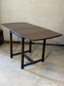 Ercol - A stained elm double drop leaf dining table, the rectangular top raised on square moulded