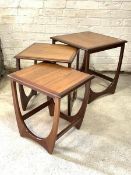 G-Plan - A Vintage teak nest of three tables, the square tops raised on shaped supports H52cm,