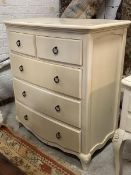 A white painted bow front chest, fitted with two short and three long drawers, raised on cabriole