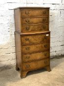 A Georgian style figured walnut bow front chest on chest, fitted with seven drawers, raised on