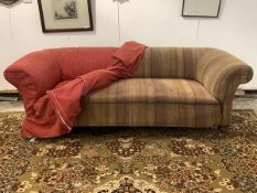 A Victorian chesterfield three seat sofa, overstuffed and sprung seat, with loose fitted red