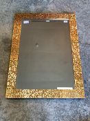 A Contemporary bevelled mirror within hammered copper frame, 64cm x 88cm