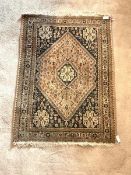 A Persian Hamadan design ground rug, with lozenge medallion on faded red field enclosed by