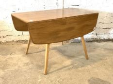 Ercol - A blonde elm and beech drop leaf dining table, the rectangular top with rounded edges raised