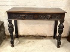 An early 20th century stained oak hall table, the rectangular top over two frieze drawers carved