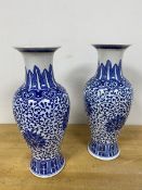 A pair of modern Chinese baluster shaped blue and white vases, both with character marks to base (