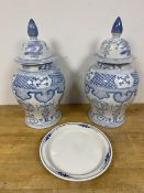 A pair of blue and white baluster shaped modern Chinese lidded vases, one with hairline crack (43cm)