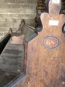 A large Victorian stained pine pew, with panelled back and seat, raised on shaped panel end supports