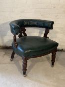 A Victorian walnut and leather tub shaped library chair, with buttoned back and overstuffed seat,
