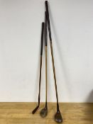 A collection of three vintage hickory shafted golfclubs including a putter inscribed Ralph Smith the