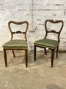 A Pair of mid 19th century rosewood balloon back chairs, with scrolled rail back, seat upholstered