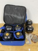 A set of four boules, each with the intials HT, in a carrying case and two other boules (a/f) and