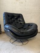 A Vintage lounge chair, circa 1970, upholstered in buttoned black faux leather, raised on a chrome