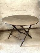 Thornton and Herne - An Edwardian stained pine coaching table, the circular top raised on a