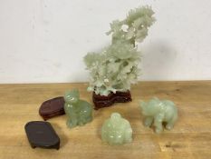 A group of three carved light green stone figures, including a Buddha, Elephant etc. and a floral