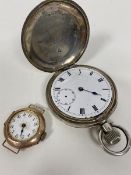 An Edwardian 9ct gold lady's wristwatch, lacking strap (a/f) and a silver Omega pocket watch (