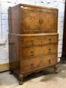 A Queen Anne style figured walnut cupboard on chest, the raised back over floral carved edge and two