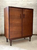A Vintage mid century teak side cabinet by Meredew, the double doors enclosing two adjustable