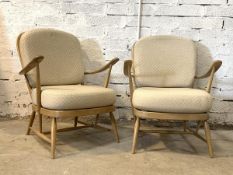 Ercol - A pair of blonde elm lounge chairs, with hoop and spindle back, upholstered cushions, raised