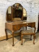 A quality Queen Anne style figured walnut dressing table, the triptych swing mirror over quarter