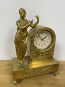 A Regency style gilt mantel clock, with Classical figure standing by clock with swan decoration,