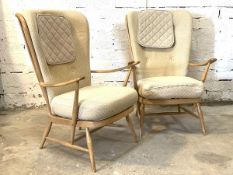 Ercol - A pair of blonde elm and beech lounge chairs, with upholstered cushions, open arm rests